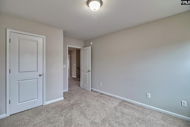 unfurnished bedroom featuring light carpet