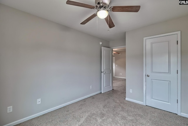 unfurnished bedroom featuring ceiling fan and light colored carpet