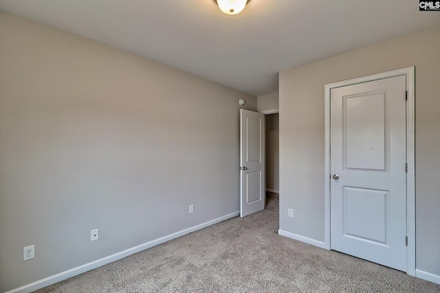 unfurnished bedroom featuring light colored carpet