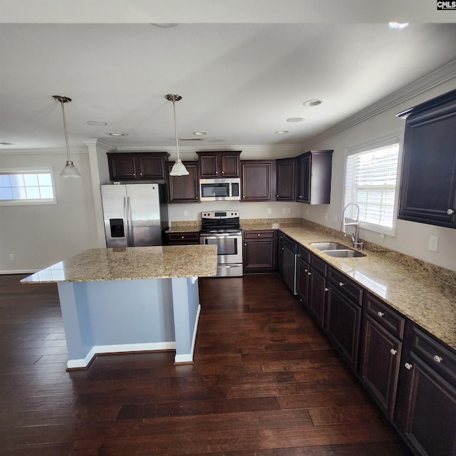 kitchen featuring dark wood-type flooring, crown molding, sink, appliances with stainless steel finishes, and decorative light fixtures