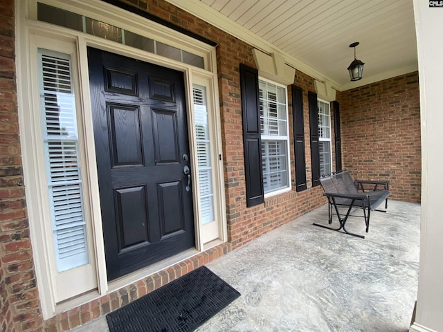 doorway to property featuring covered porch