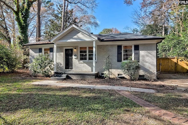 view of front of house with covered porch and a front yard