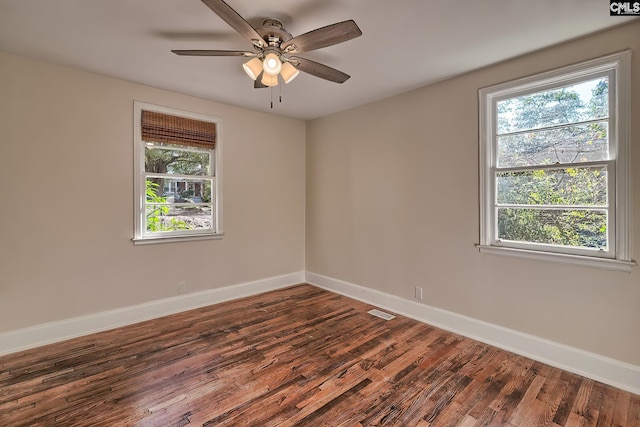 spare room featuring ceiling fan and dark wood-type flooring