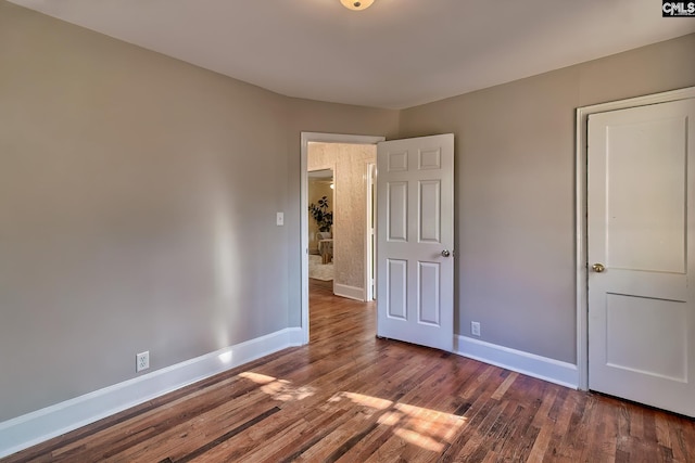 unfurnished bedroom featuring dark hardwood / wood-style flooring