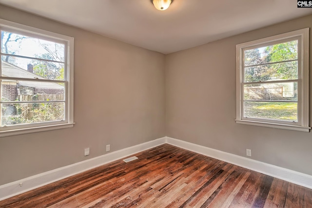 unfurnished room featuring hardwood / wood-style flooring