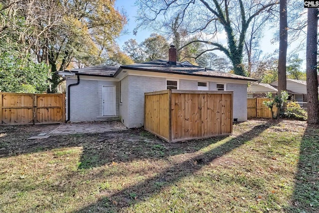 view of outbuilding featuring a lawn