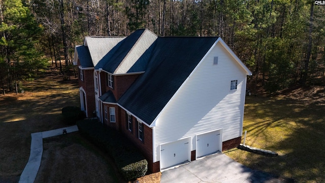 view of property exterior with a yard and a garage