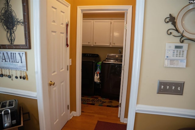 corridor featuring independent washer and dryer and wood-type flooring