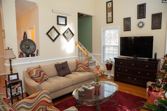 living room with light hardwood / wood-style flooring and ornamental molding