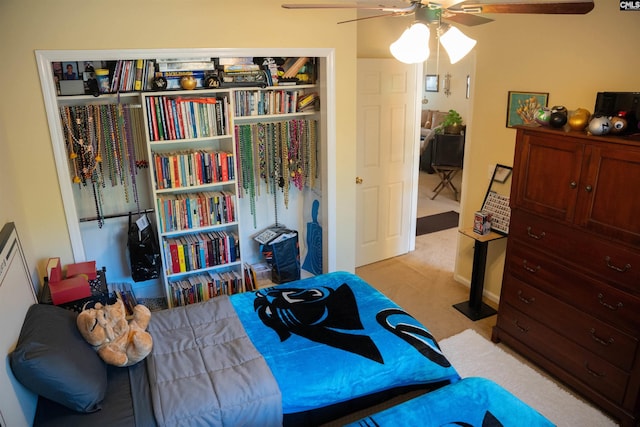 bedroom with ceiling fan and light carpet