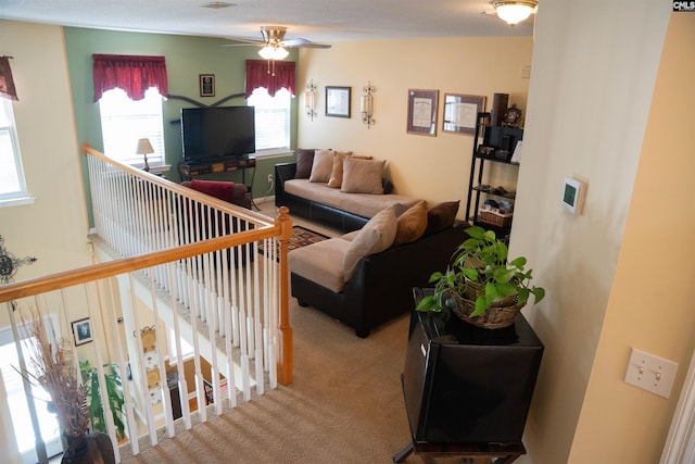 living room featuring ceiling fan and light carpet