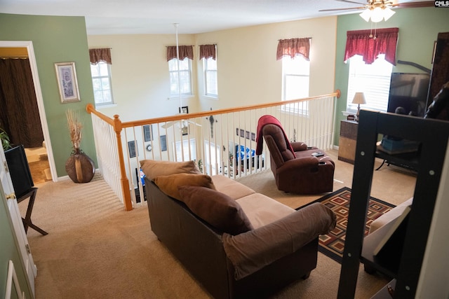 living room featuring ceiling fan and light carpet