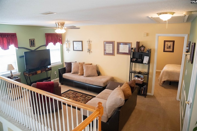 carpeted living room featuring a textured ceiling and ceiling fan