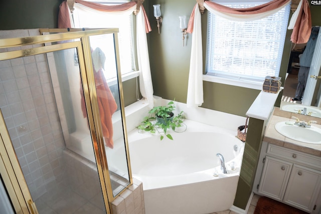 bathroom with vanity and separate shower and tub