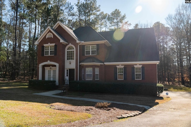 view of front facade with a front yard and french doors