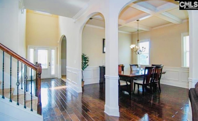 dining room with beamed ceiling, dark hardwood / wood-style flooring, ornamental molding, and coffered ceiling