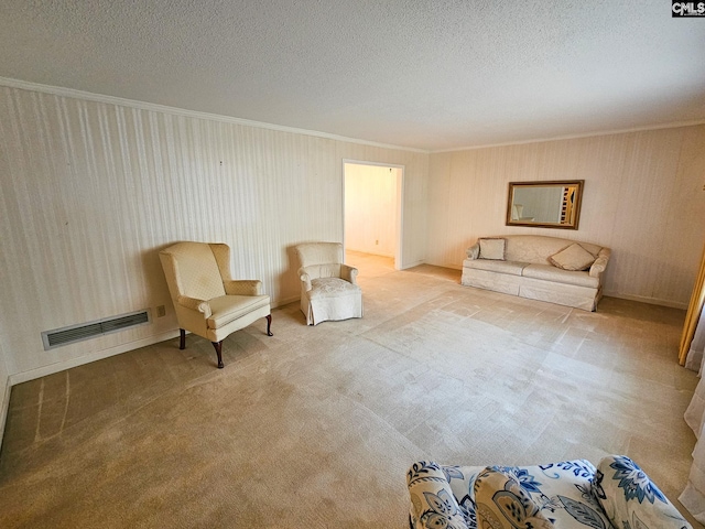 living area with a textured ceiling, carpet floors, and crown molding