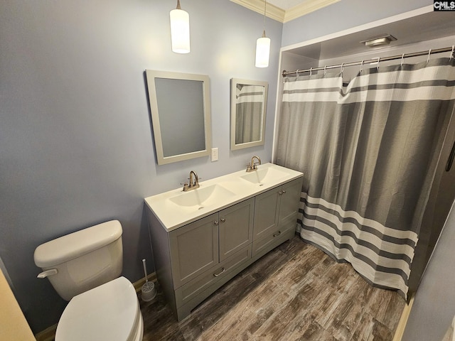 bathroom with a shower with curtain, crown molding, toilet, vanity, and hardwood / wood-style flooring