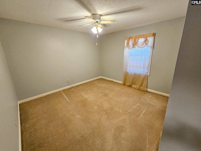 carpeted empty room with a textured ceiling and ceiling fan