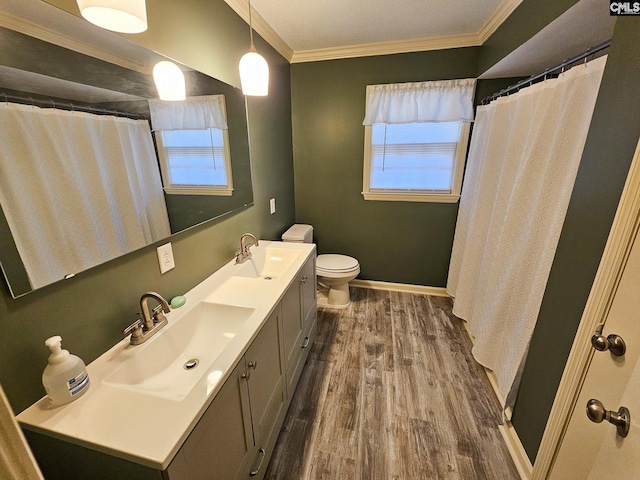 bathroom featuring hardwood / wood-style floors, vanity, toilet, and ornamental molding