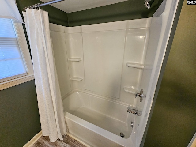 bathroom featuring hardwood / wood-style floors and shower / tub combo with curtain