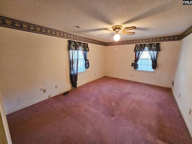 carpeted empty room with ceiling fan and a textured ceiling