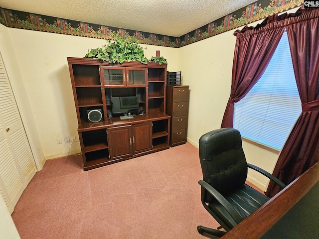 office area with carpet floors and a textured ceiling