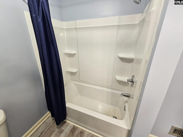 bathroom featuring shower / bath combination with curtain and wood-type flooring