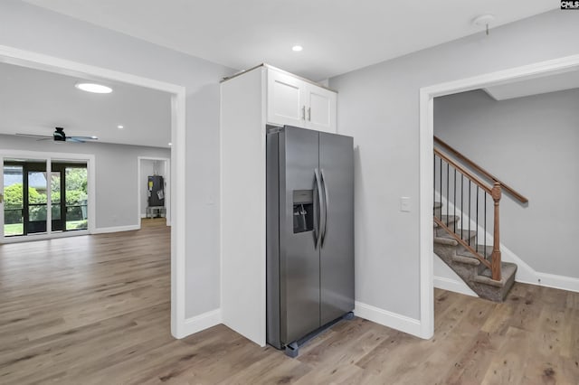 kitchen featuring stainless steel fridge, light hardwood / wood-style floors, white cabinetry, and ceiling fan