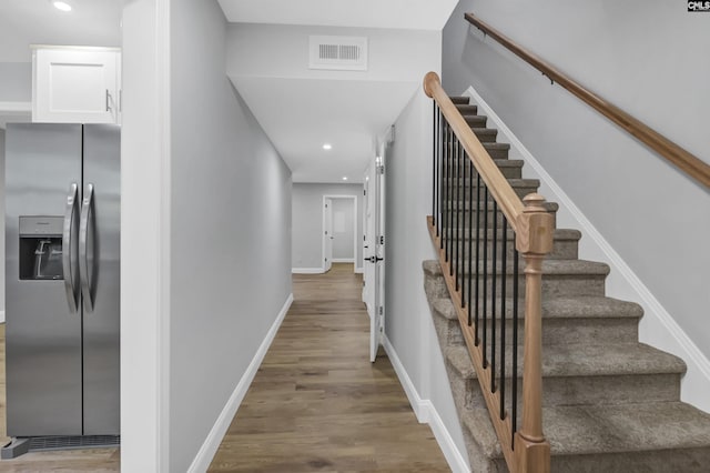 stairs with hardwood / wood-style floors