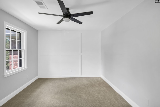 carpeted empty room featuring ceiling fan