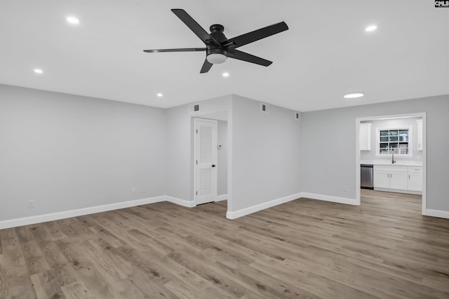 unfurnished living room featuring ceiling fan and light wood-type flooring