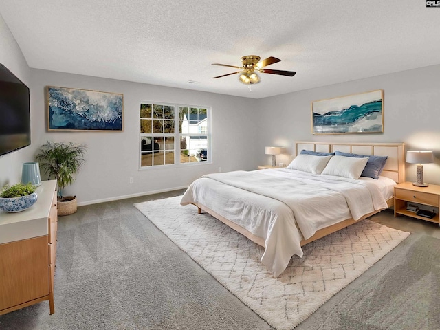 bedroom featuring carpet flooring, ceiling fan, and a textured ceiling