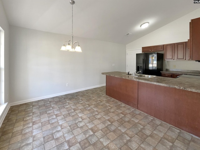 kitchen with lofted ceiling, black refrigerator with ice dispenser, sink, decorative light fixtures, and a notable chandelier