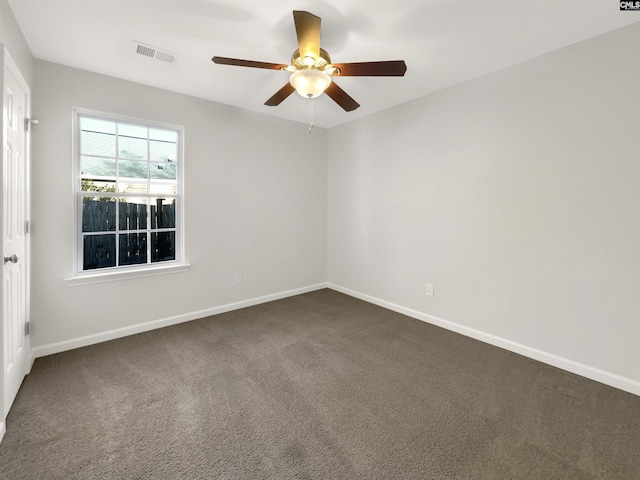 carpeted spare room featuring ceiling fan