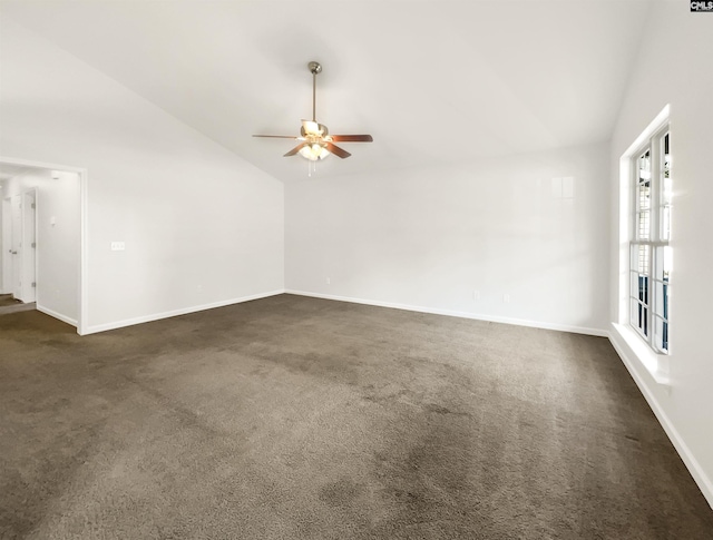 empty room with dark colored carpet, high vaulted ceiling, and ceiling fan