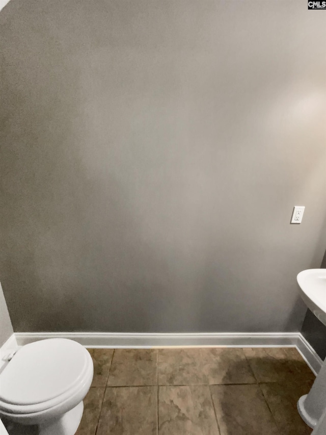 bathroom featuring tile patterned flooring and toilet