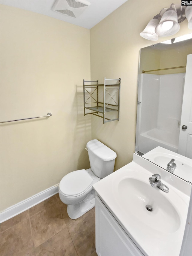 bathroom with tile patterned flooring, toilet, vanity, and walk in shower