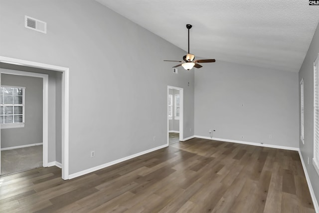 unfurnished living room featuring ceiling fan, dark hardwood / wood-style flooring, high vaulted ceiling, and a textured ceiling