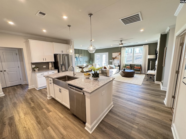 kitchen featuring appliances with stainless steel finishes, open floor plan, visible vents, and white cabinets