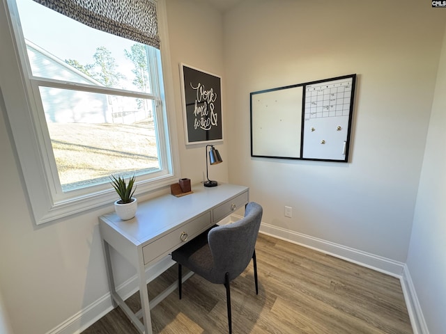 office area with baseboards and wood finished floors