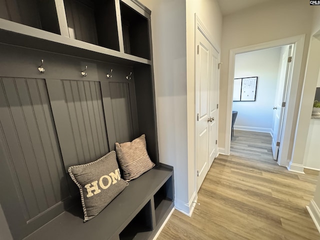 mudroom featuring light wood-type flooring and baseboards