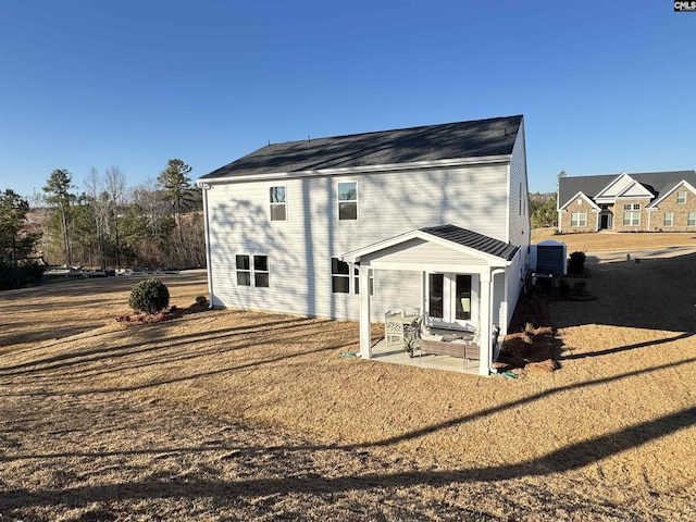 back of property with a patio and a lawn