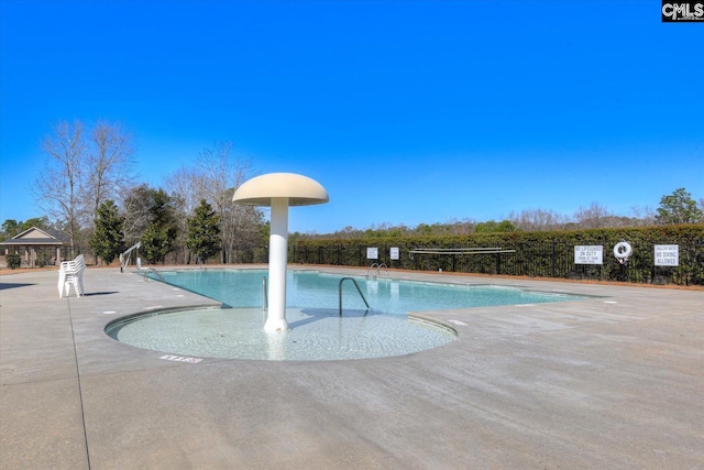 community pool with a patio area