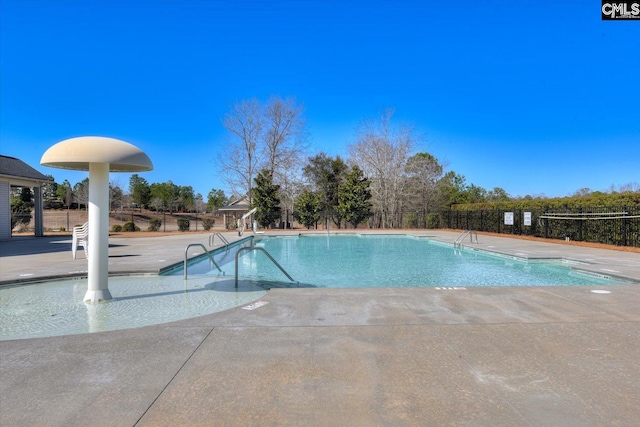 community pool featuring a patio area and fence