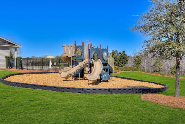 communal playground featuring a yard and fence