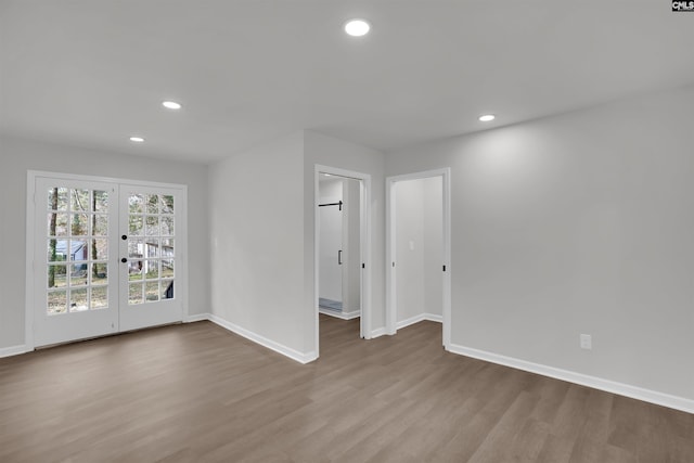 unfurnished room featuring french doors and light hardwood / wood-style floors