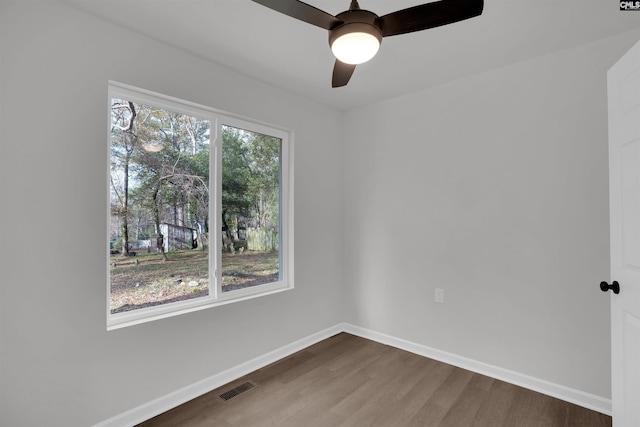 spare room featuring wood-type flooring and ceiling fan