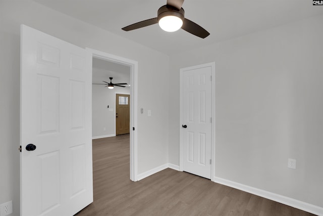 empty room with ceiling fan and wood-type flooring