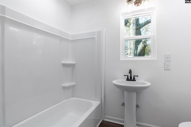 bathroom with tub / shower combination and sink